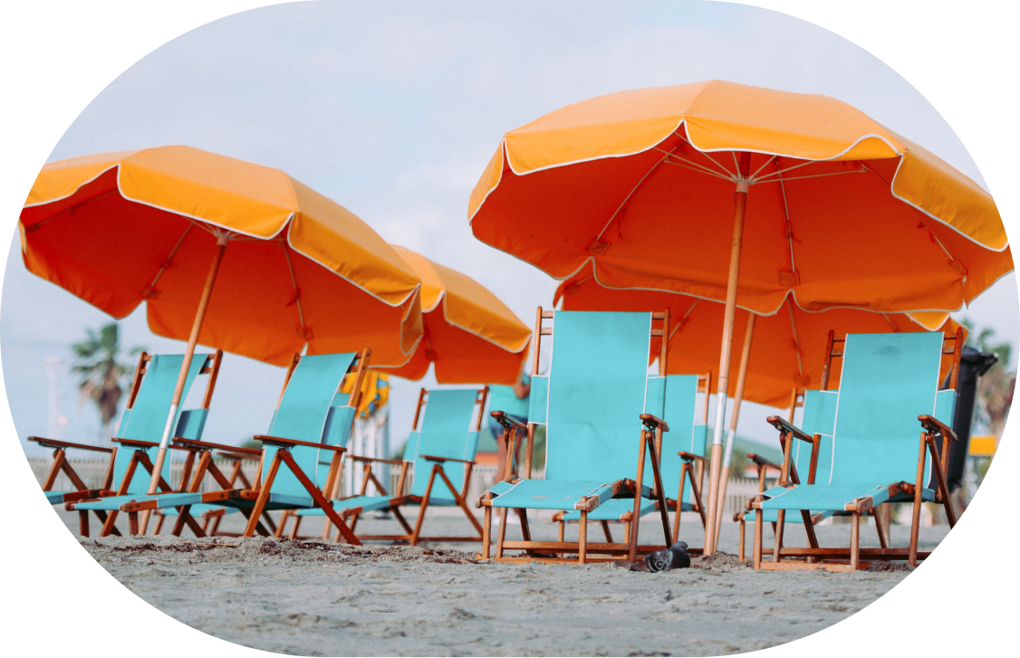 Empty beach chairs with umbrellas