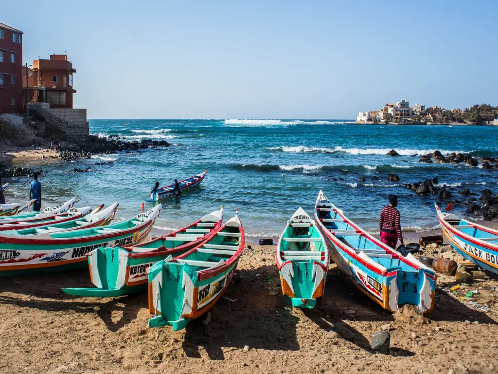 beach in Dakar with colorful boats. 