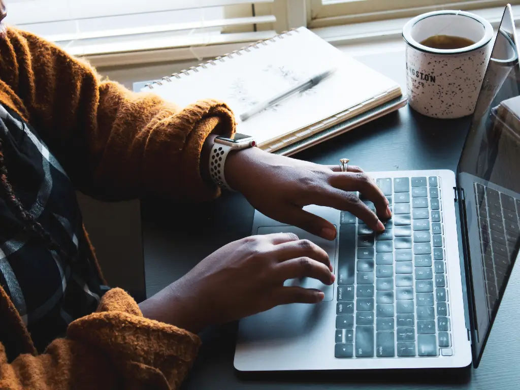 person typing on a laptop.