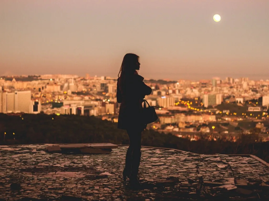Woman standing at viewpoint in Lisbon