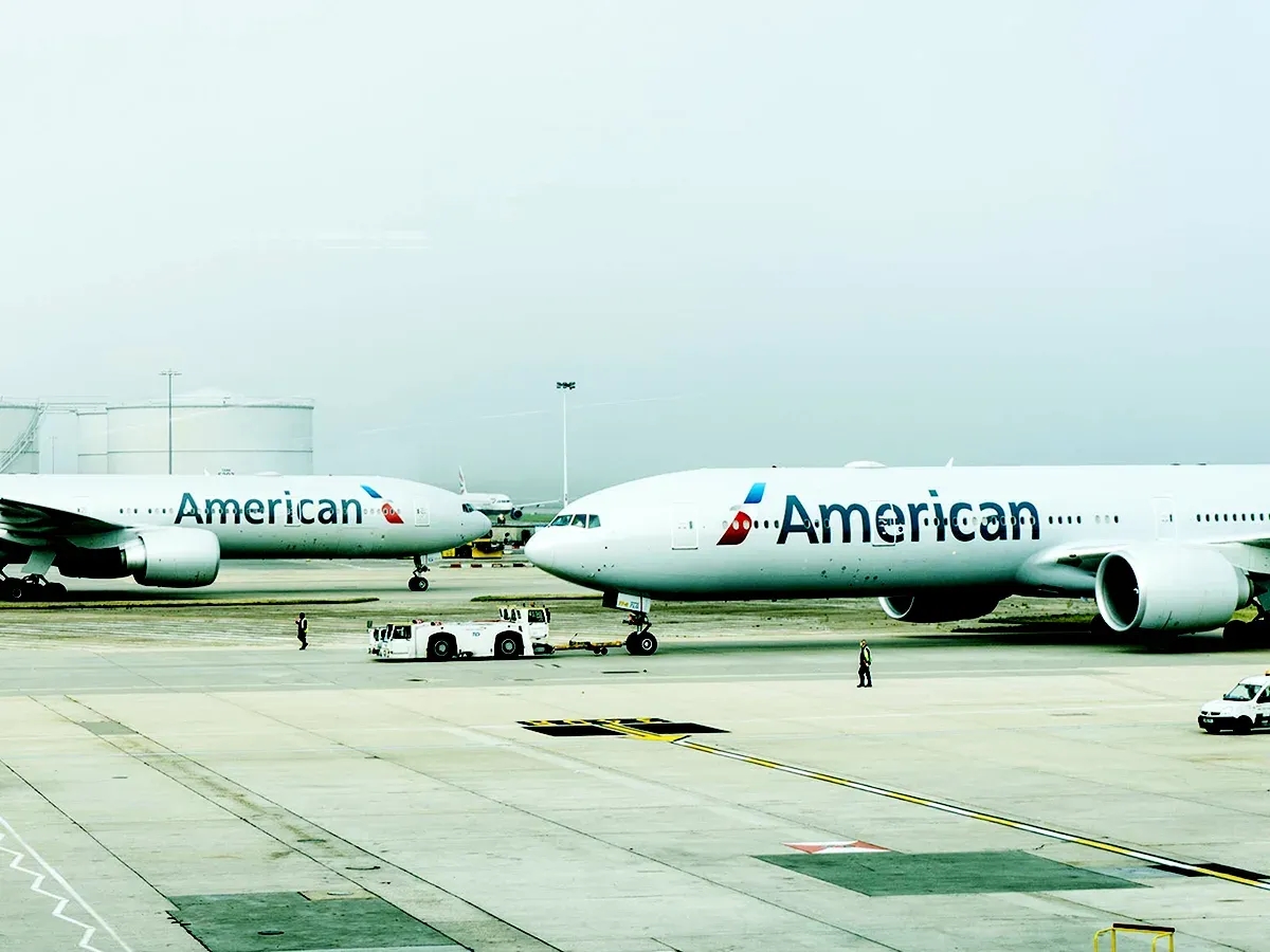 A photograph of two airplanes on the tarmac of an airport