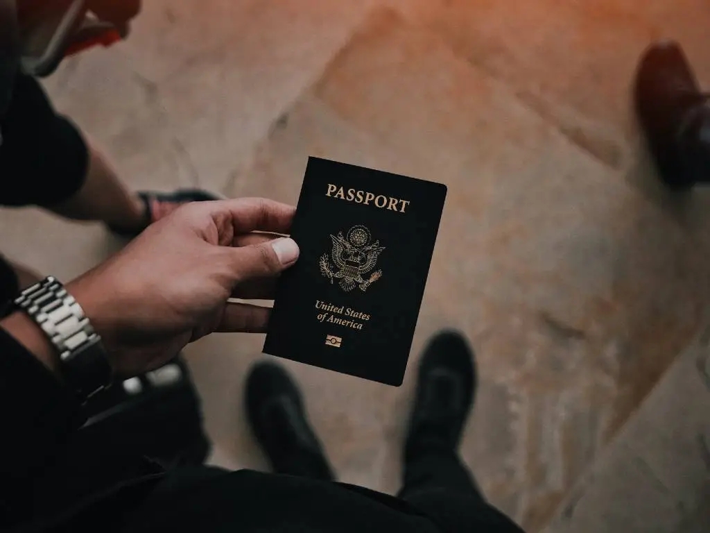 hand holding blue US passport book.