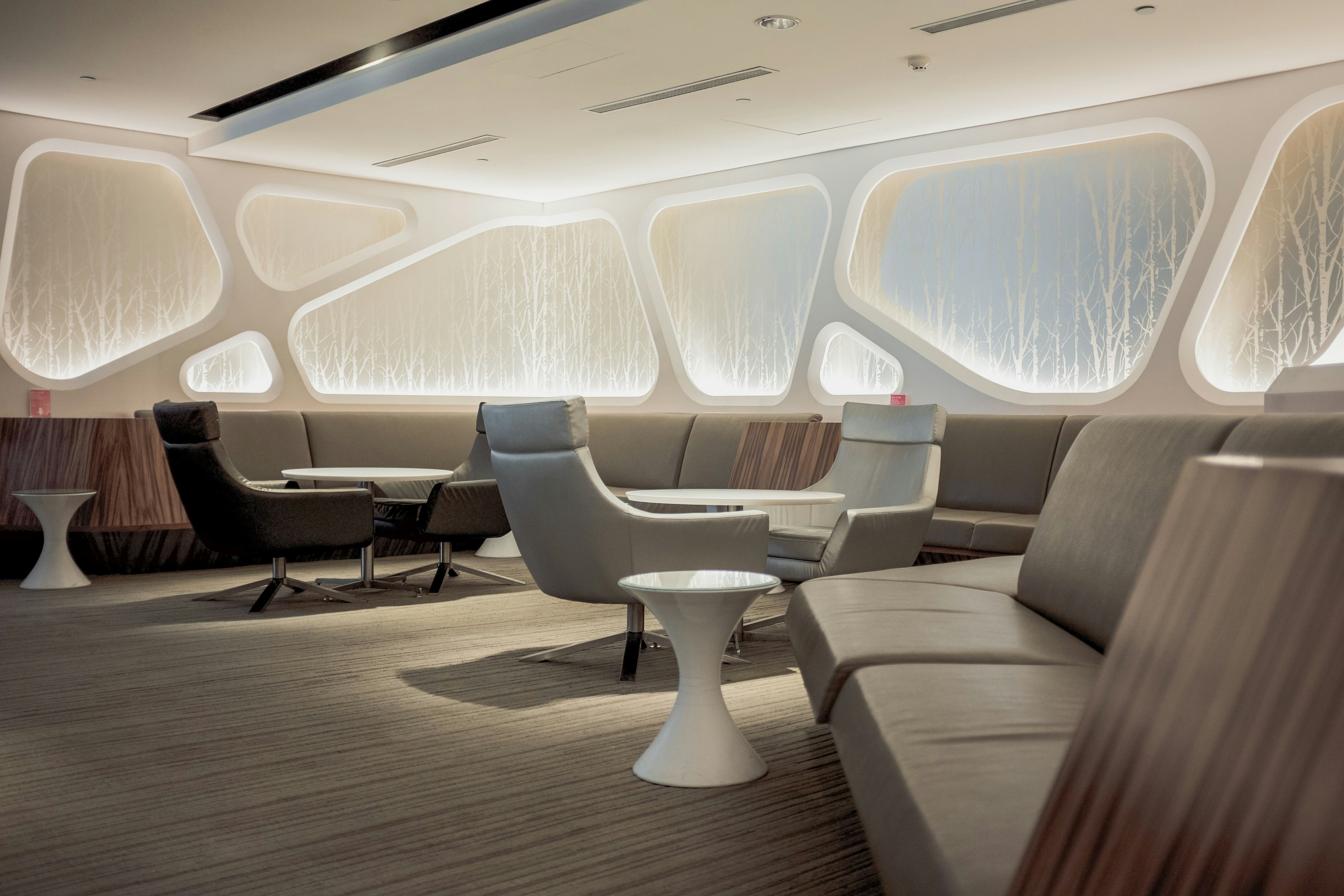 A photograph of a somewhat futuristic-looking airport lounge