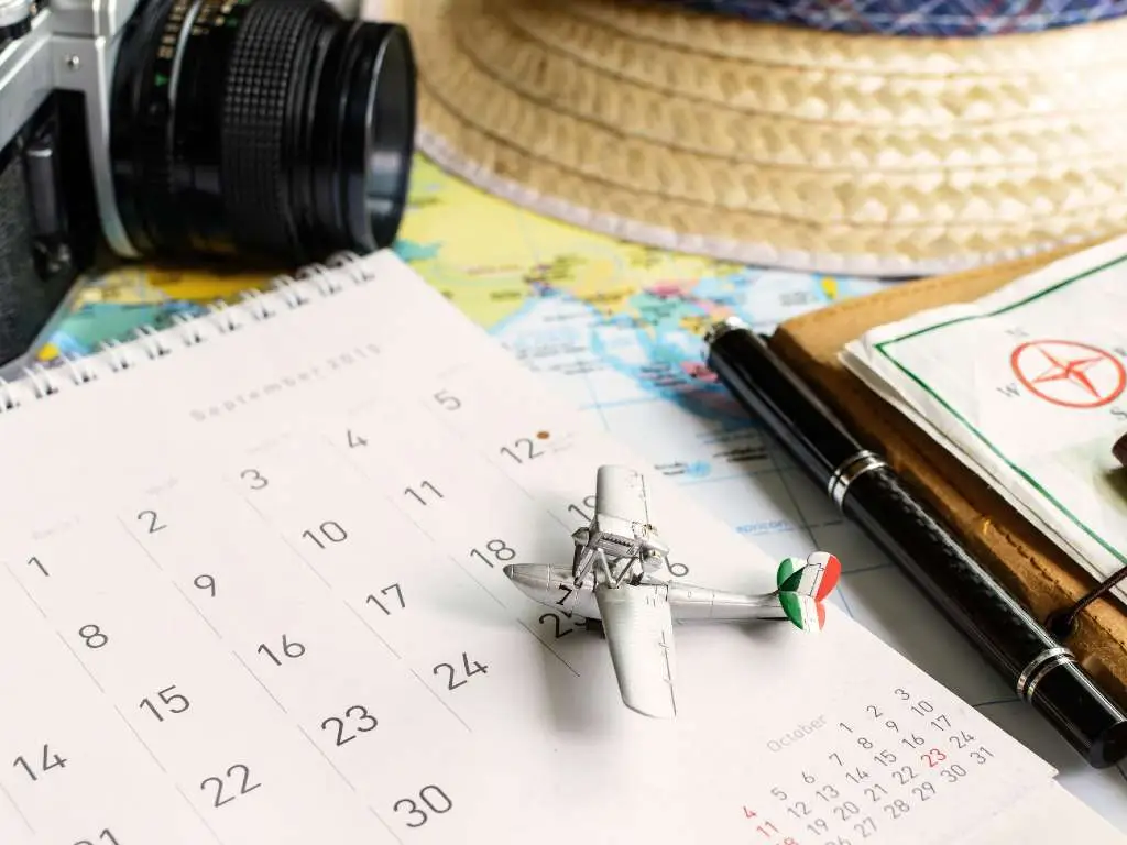 a toy airplane sitting on a calendar