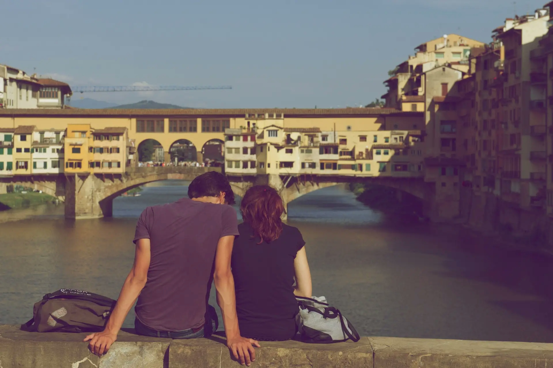 couple sitting on bridge in Florence