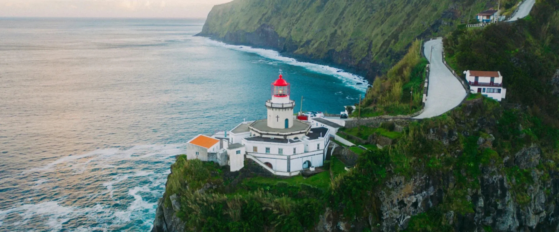 A lighthouse on the edge of a cliff in the Azores