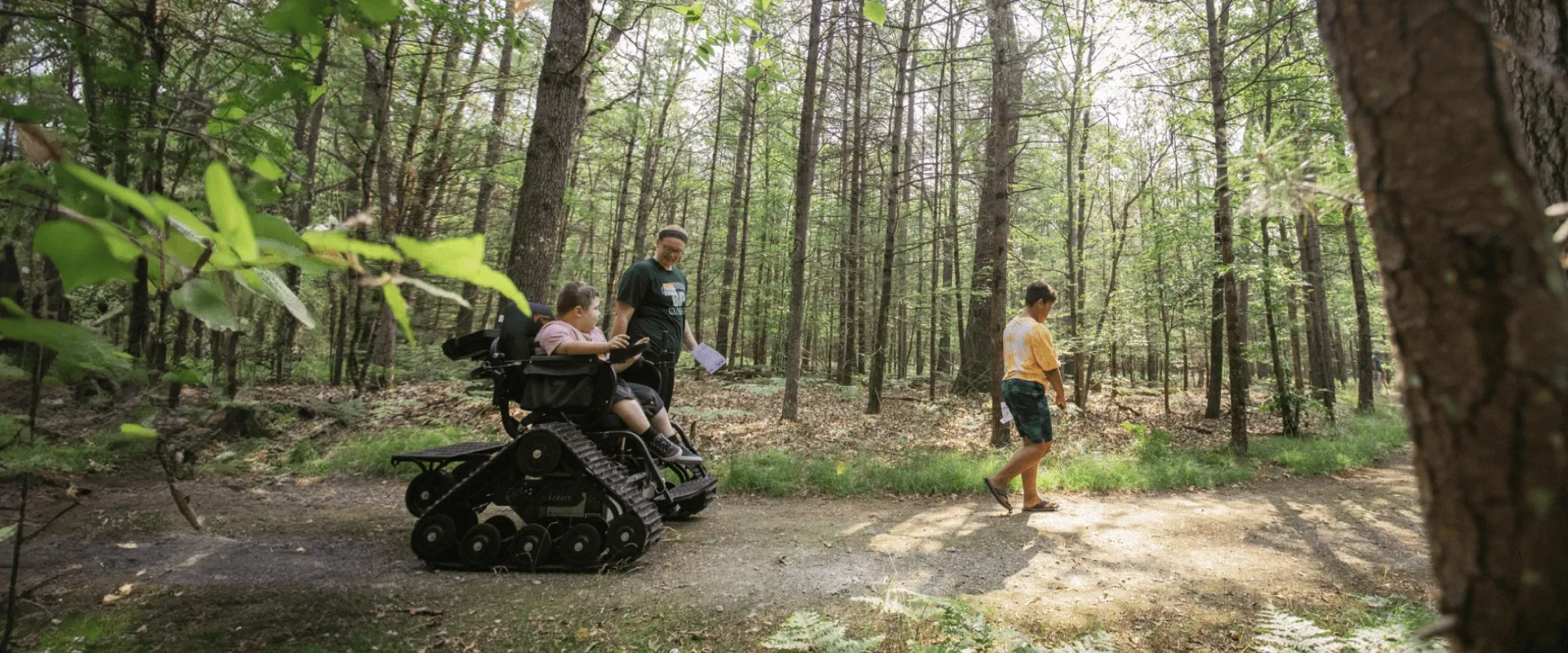 A young person drives an all-terrain track chair in Muskegon Luge Adventure Sports Park
