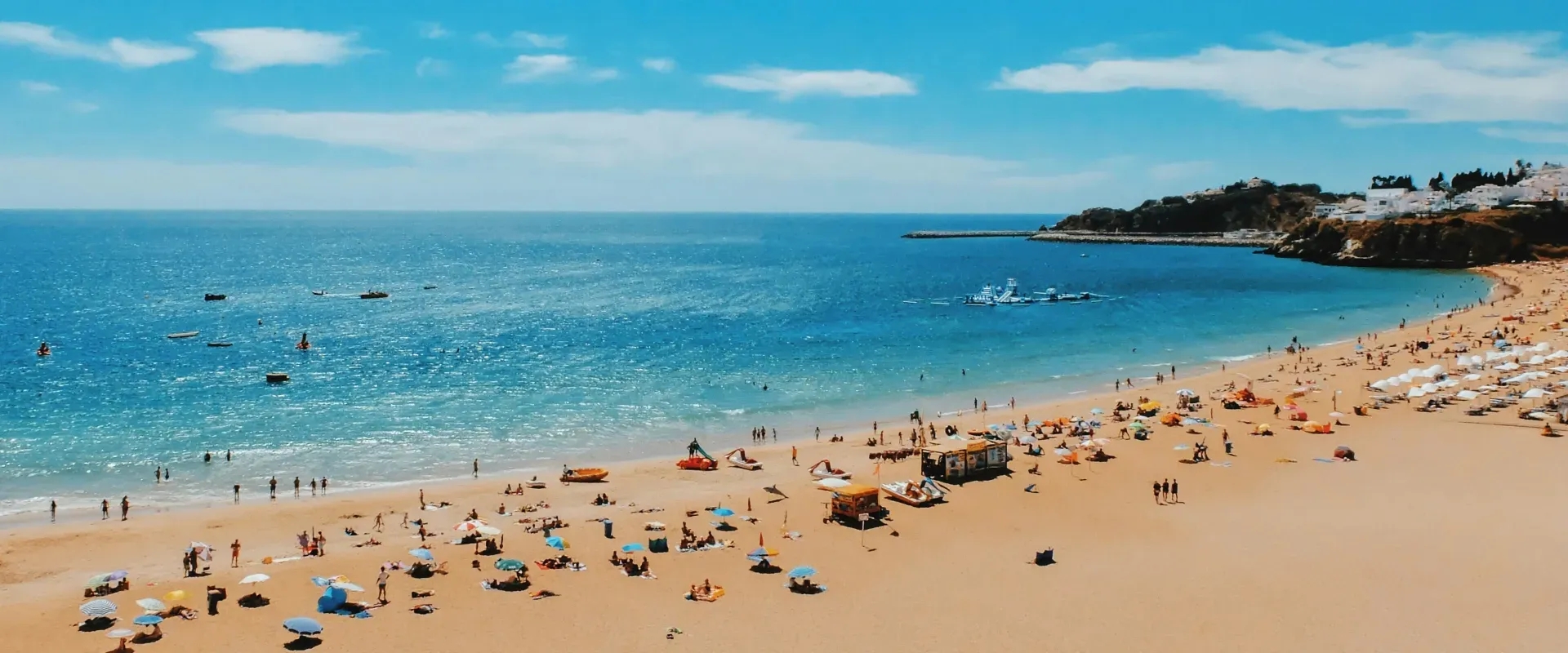 People lay on a beach in the Algarve, Portugal