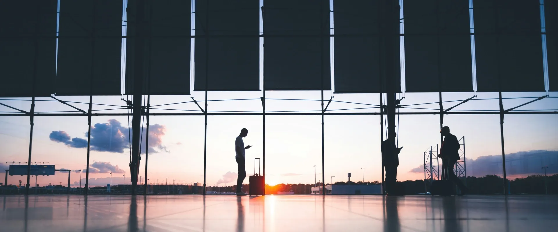 People stand in an airport terminal