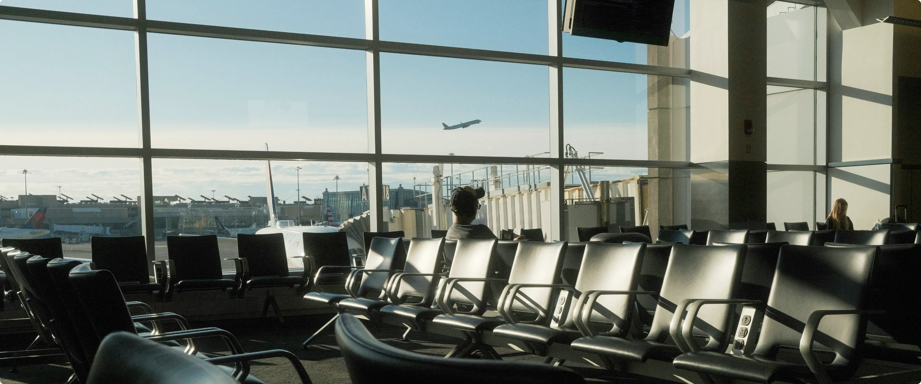 View from inside the airport terminal of flight taking off