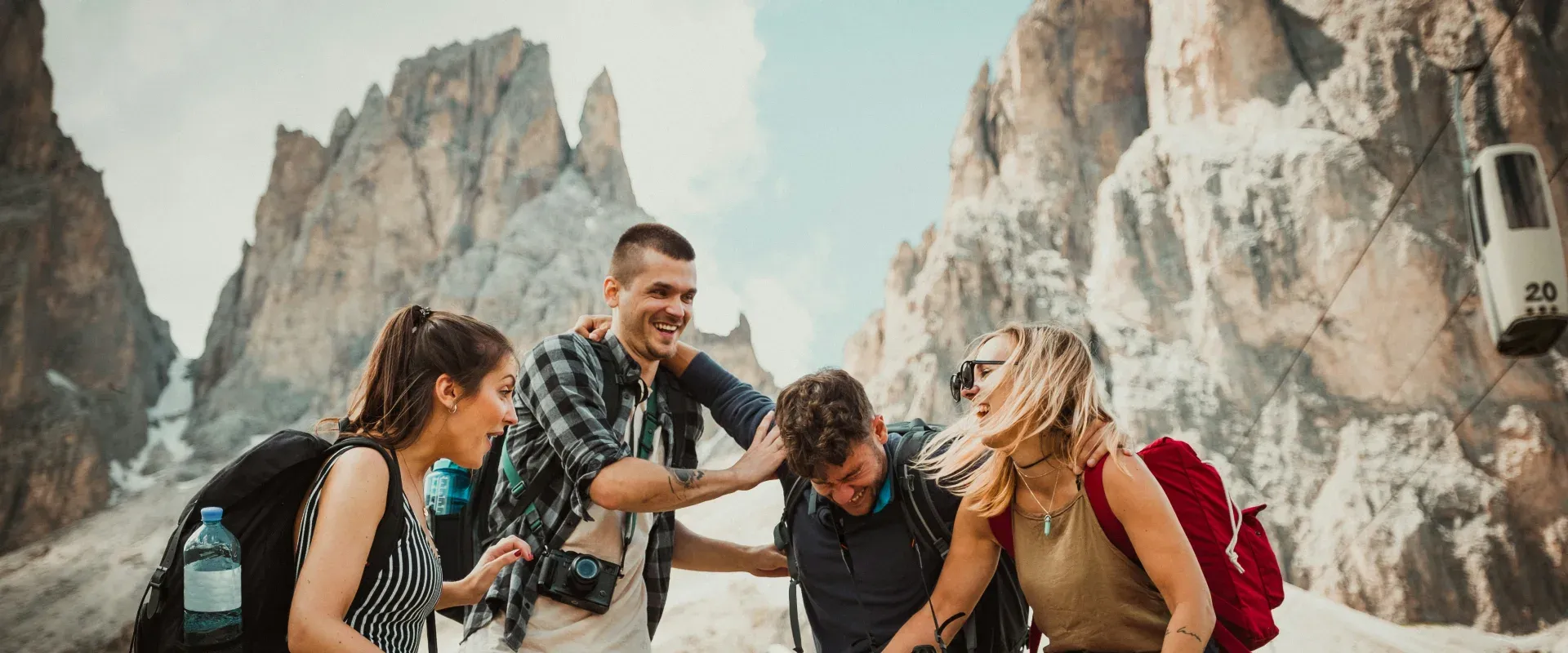 A group of travelers stands in front of rock formations
