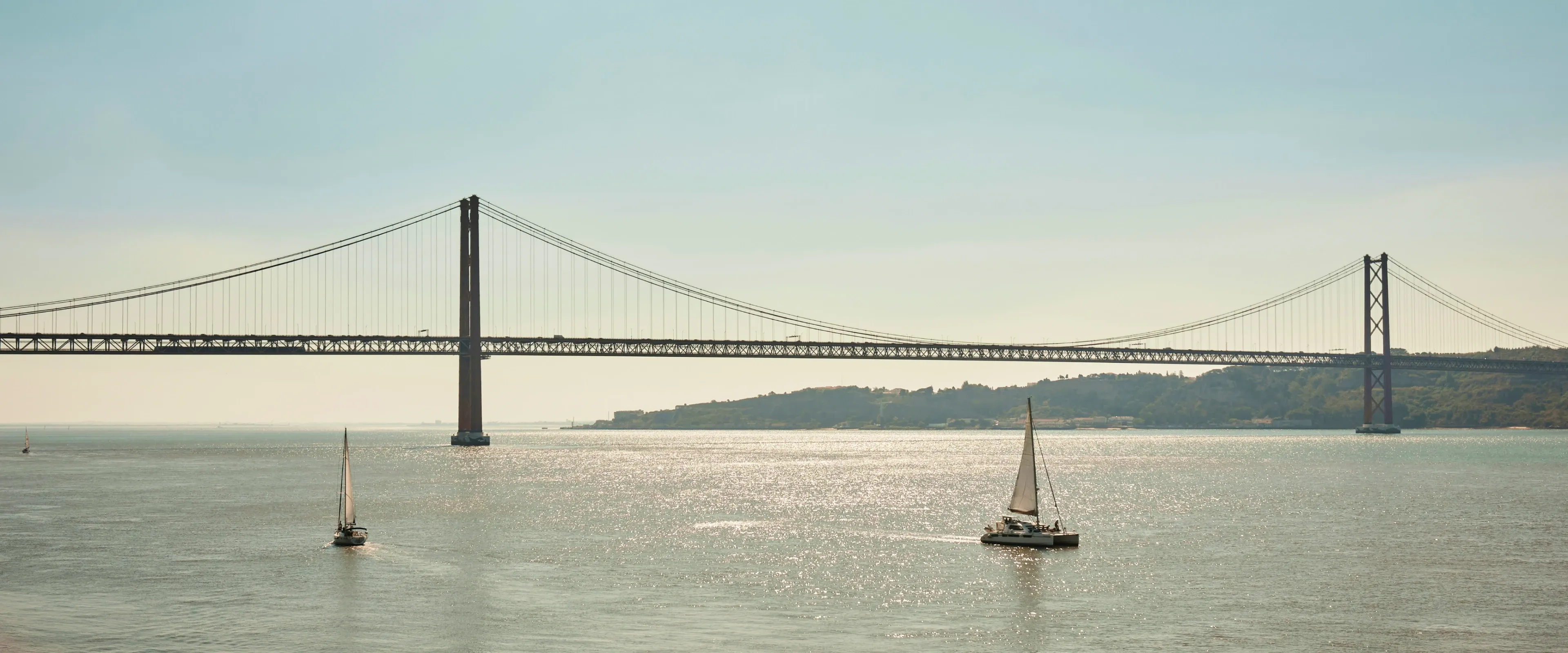A bridge and sailboats in Lisbon