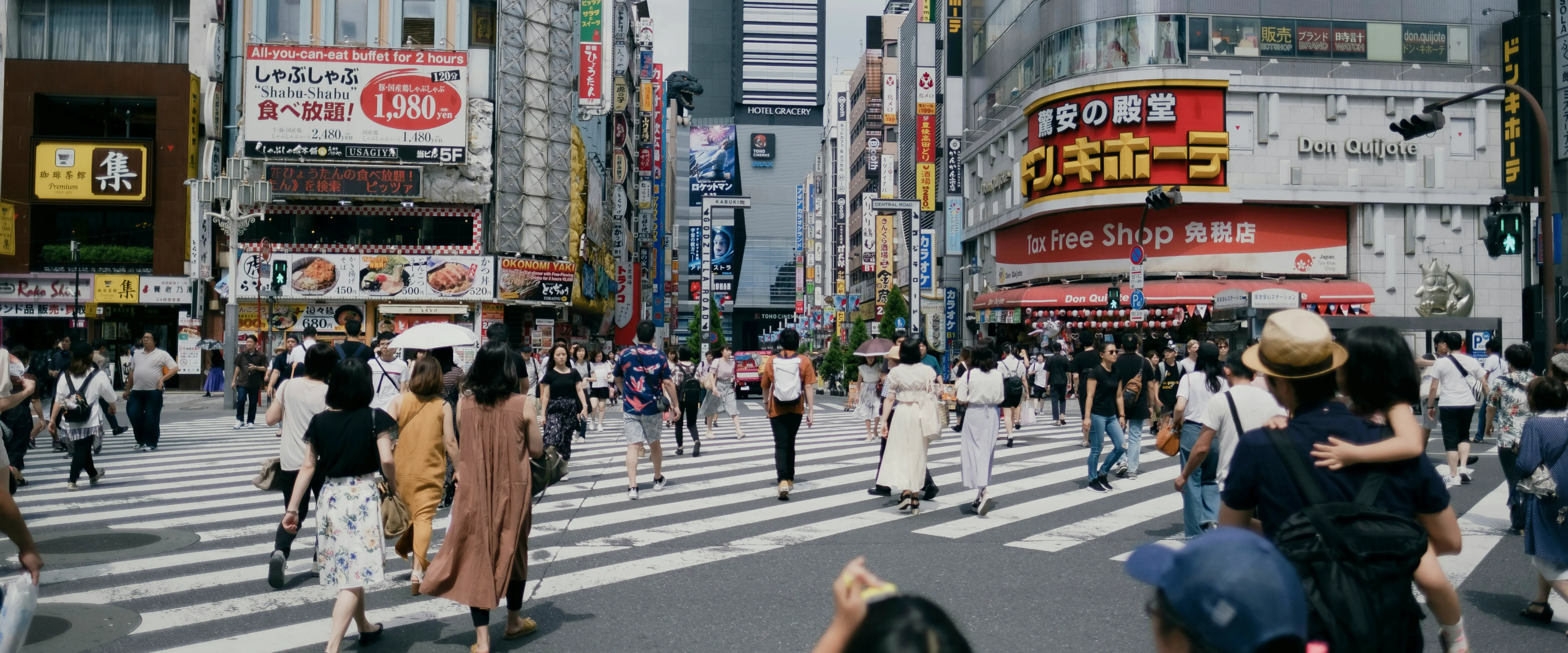 People walk across a busy intersection in Tokyo