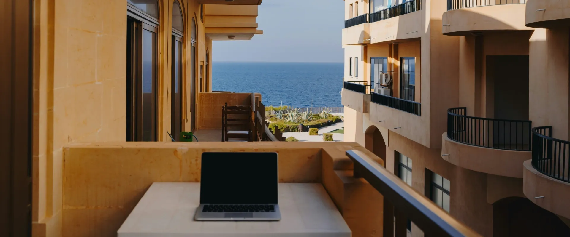 Laptop sits on a balcony