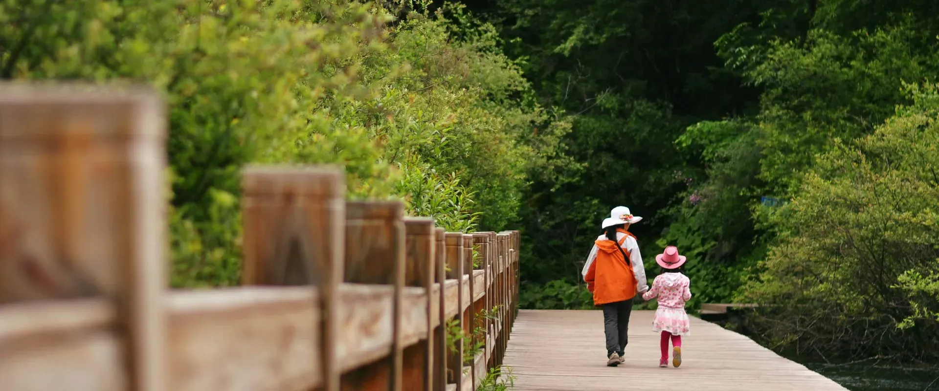 Mom and child walk hand in hand on dock