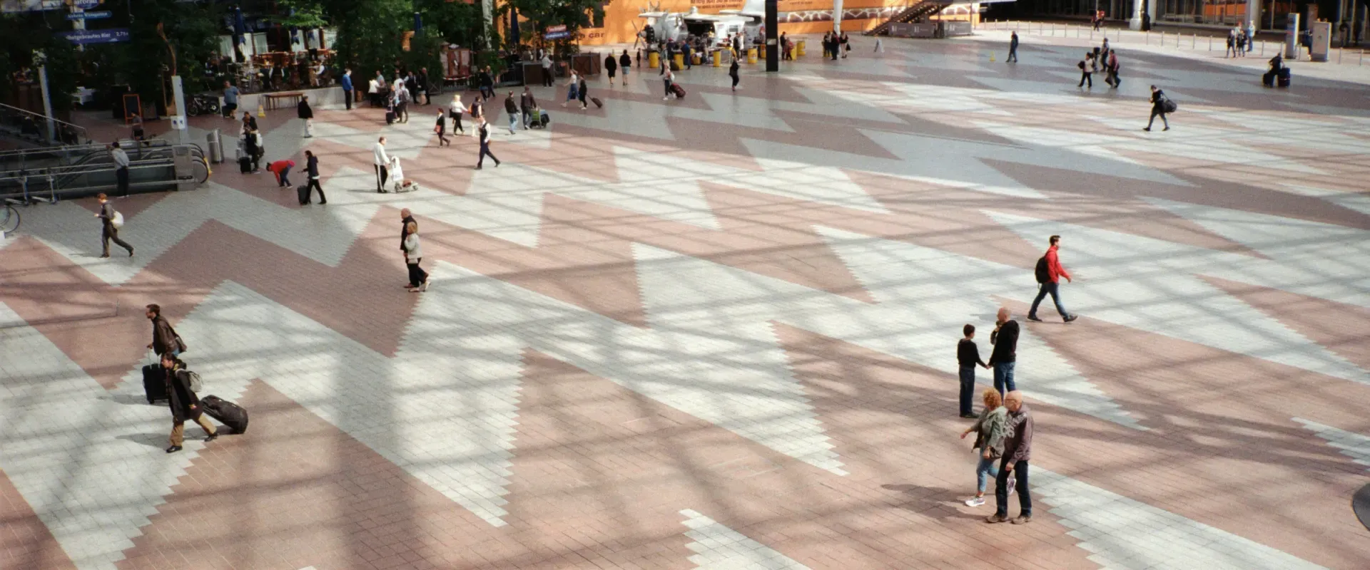 People walk through airport with suitcases