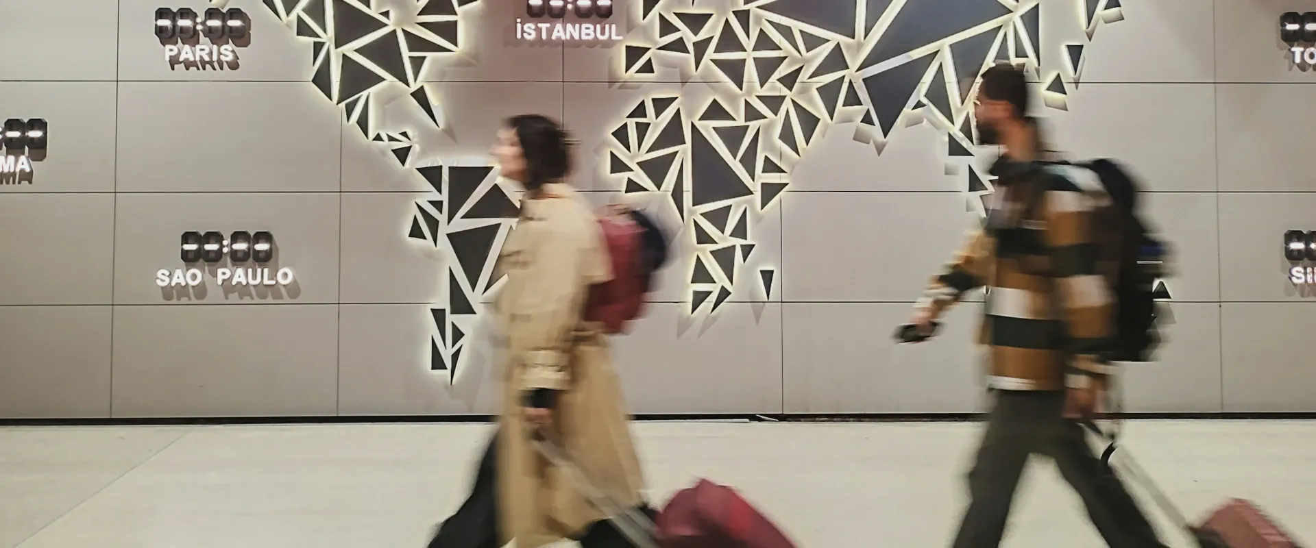 Travelers walking through airport with luggage