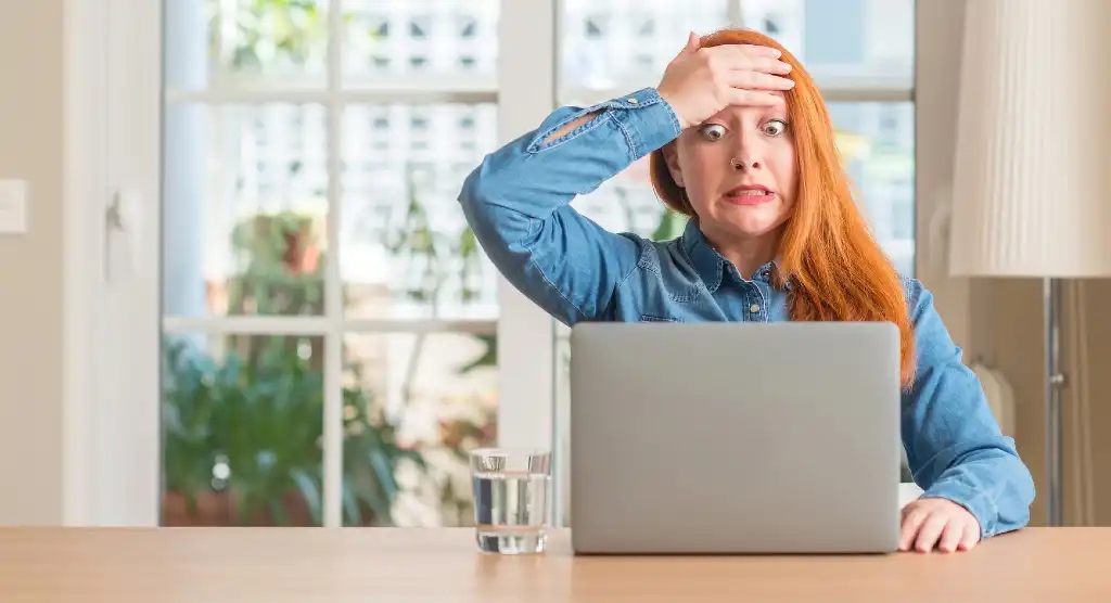 woman face palm at computer