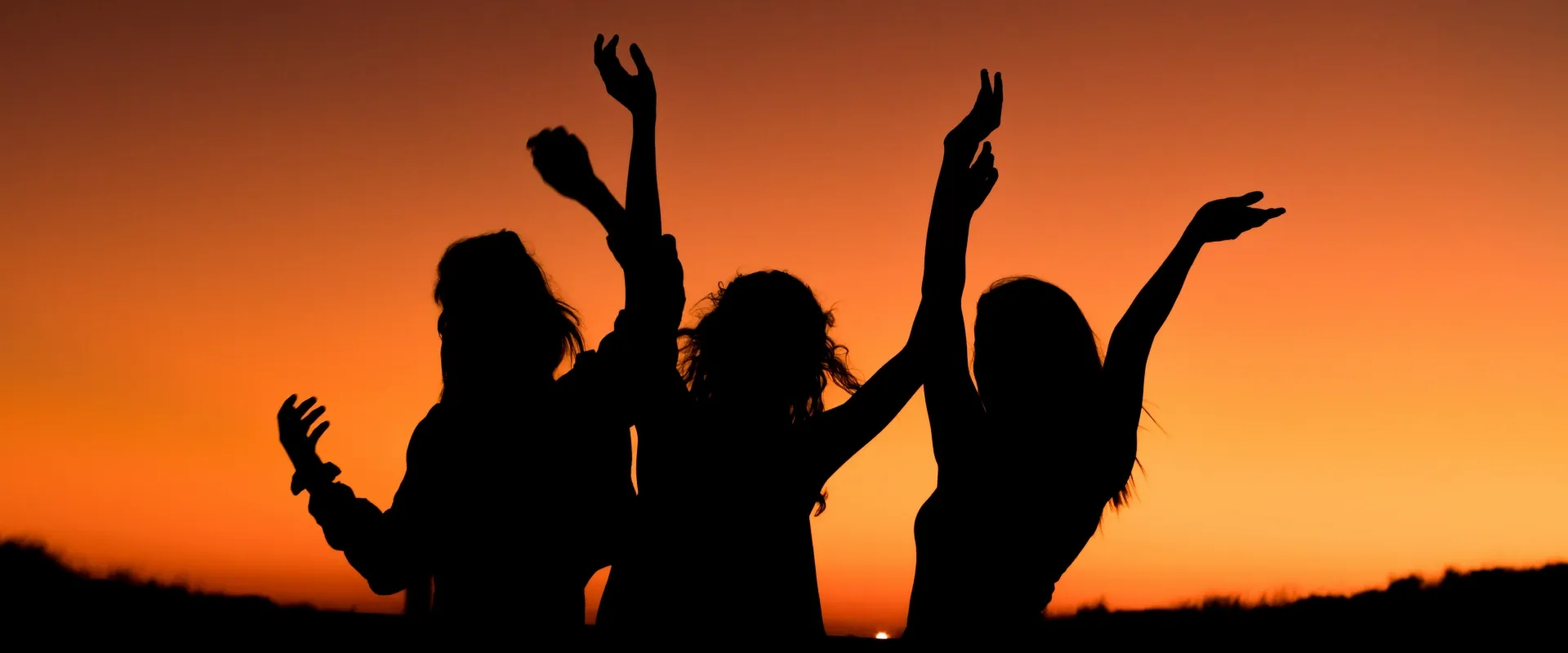 Women traveling and celebrating at sunset
